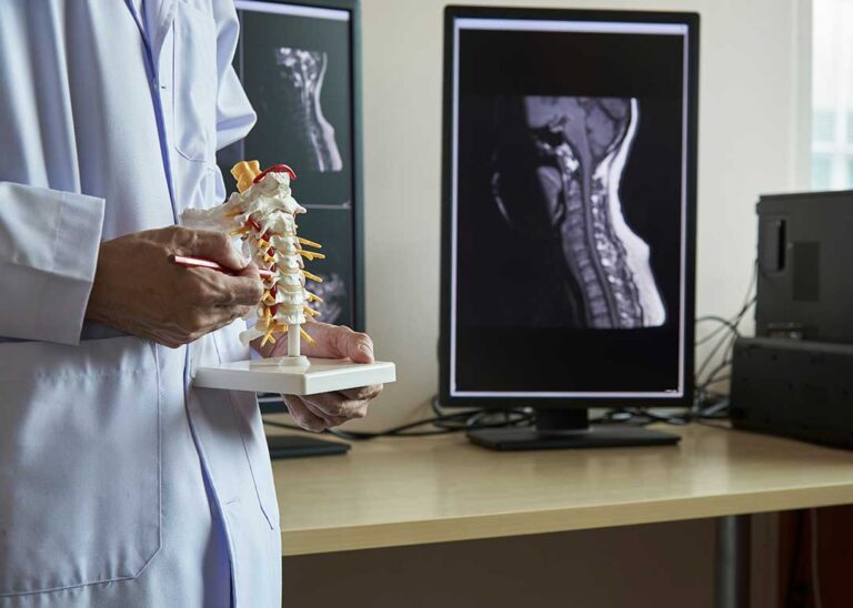 Person resting comfortably in bed while a clinician discusses back pain and sleep patterns nearby.